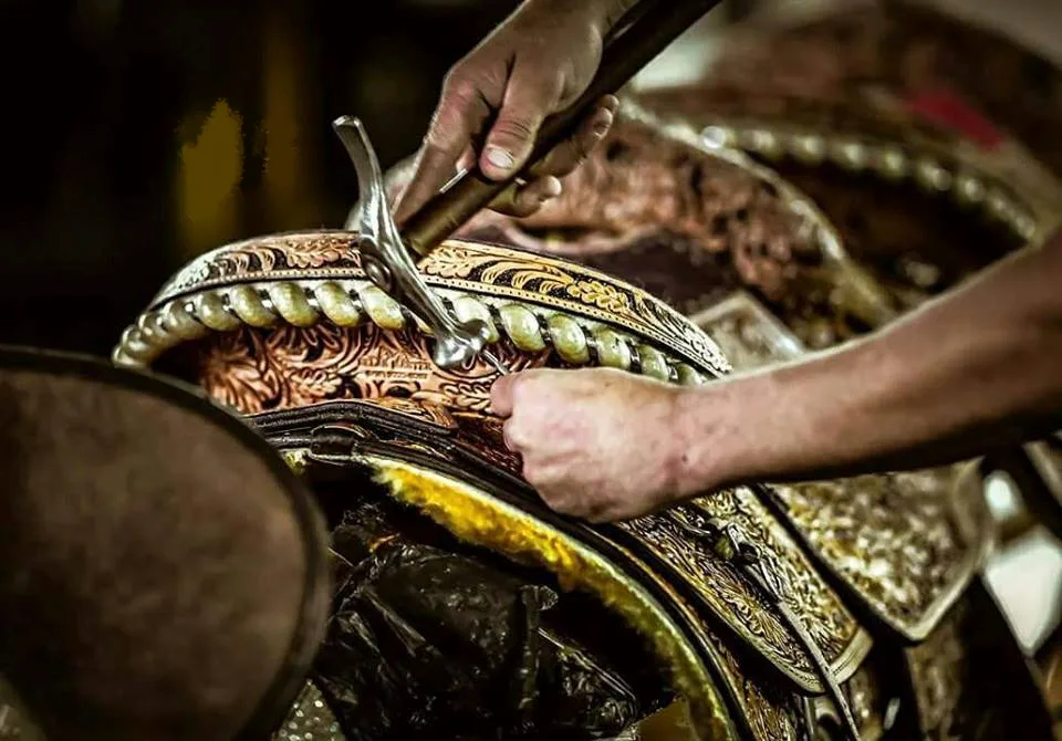 Artisan tooling a saddle by hand
