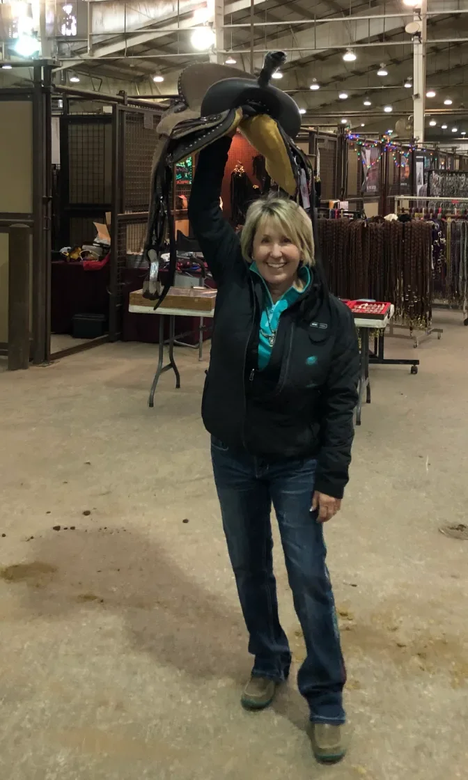 Master Saddles team member at the arena with a custom saddle